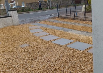 Front garden landscaped with gravel and a stepping-stone path