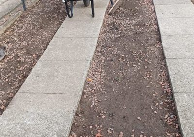 Side path build with wheelbarrow and materials in place